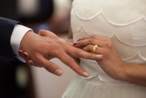 couples counseling bride puts ring on groom